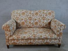 A 19th century century mahogany framed upholstered two seater settee, raised on square tapering