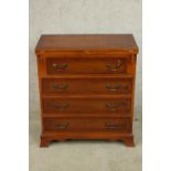 A contemporary Yew wood bachelors style chest of four graduating drawers with rotating foldover