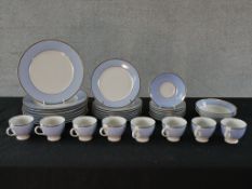 A Doulton porcelain part tea and dinner service, with pale blue border within a silver resist rim.