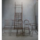 Two pairs of wrought iron garden chairs, together with a wrought iron garden table and a wrought