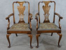 A pair of 20th century mahogany framed open arm chairs with pierced splat backs raised on cabriole