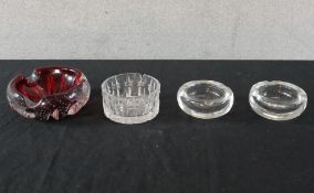 A pair of Murano clear heavy glass ash trays together with two other glass ashtrays. H.6 W.16 D.10cm
