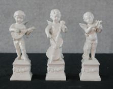 Three 19th century white glazed porcelain figures of cherubs playing musical instruments raised on