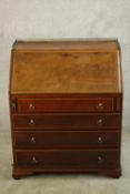 An Edwardian inlaid mahogany fall front writing bureau, with brass pierced gallery, the fall front