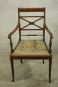An Edwardian inlaid mahogany pierced backed open arm dining chair, with embroidered drop in seat,