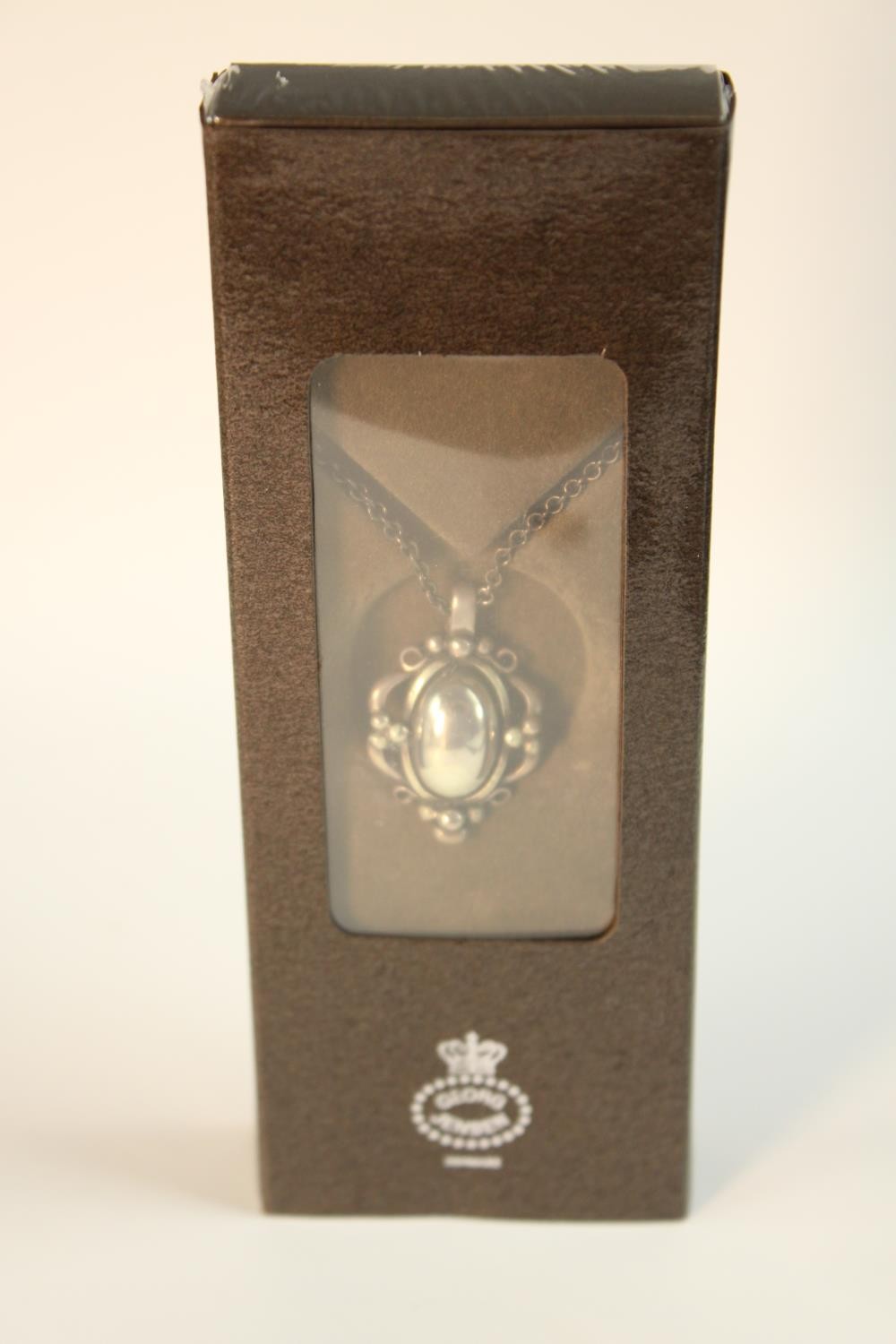Georg Jensen- a boxed as new sterling silver 1989 Annual floral and foliate design pendant and