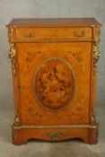 An 20th century French inlaid single door cabinet raised on shaped bracket feet, applied