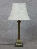 An early 20th century brass and onyx Corinthian column table lamp raised on stepped square base. H.