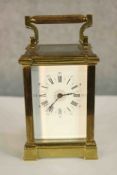 A late 19th/early 20th century brass cased carriage clock with white painted dial with black painted