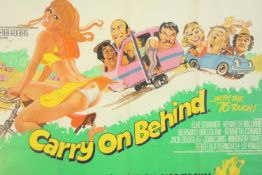 A Carry on Behind (1975) framed and glazed British Quad film poster. H.83 W.108cm.