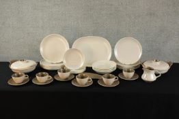 A 20th century Poole pottery brown twin tone six person part dinner set, marks verso. (39 pieces)