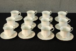 Twelve 20th century Royal Standard white painted porcelain cups and saucers, each with gold