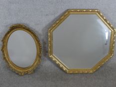 A contemporary octagonal shaped gilt framed wall mirror, together with an oval gilt framed wall