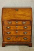 A contemporary mahogany television/video stand formed as a George III bureau raised on shaped shaped