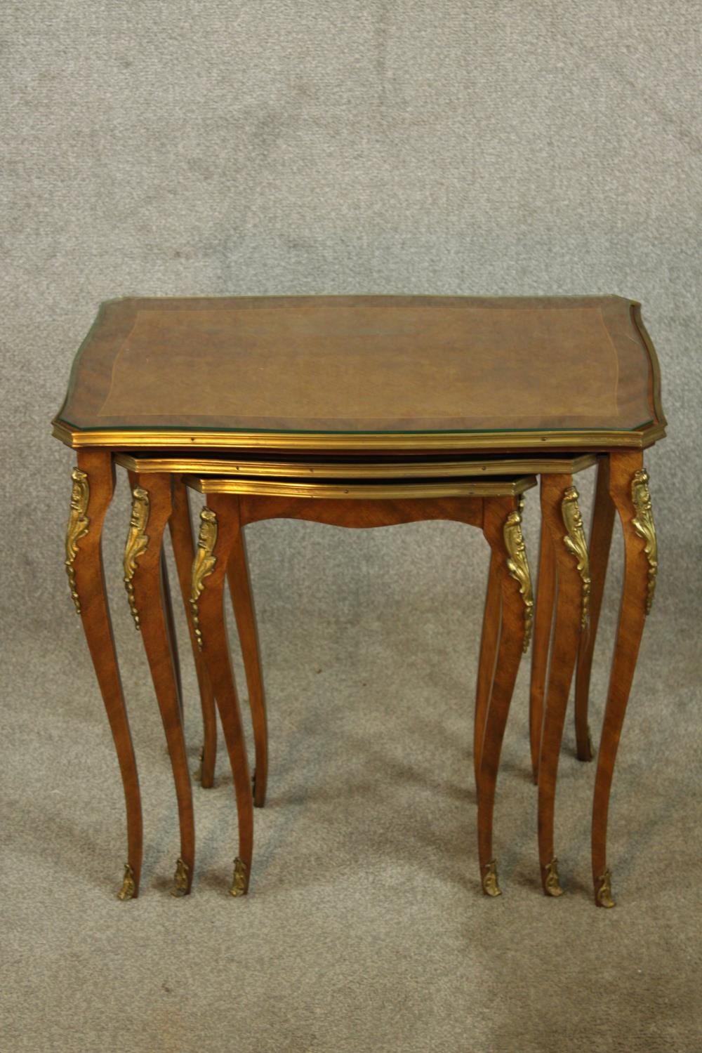 An early 20th century nest of three French Kingswood and gilt metal mounted inter sliding occasional