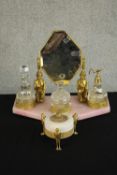An Art Deco Egyptian Revival pink marble and gilt metal dressing table set complete with glass scent
