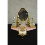 An Art Deco Egyptian Revival pink marble and gilt metal dressing table set complete with glass scent