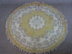 A 20th century yellow ground Chinese circular carpet, embroidered with floral decoration. W.186 D.