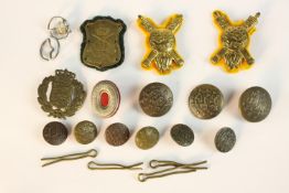 A collection of Danish military badges and uniform buttons, various designs.