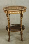An early 20th century Egyptian Revival mahogany and ebony inlaid oval two tier side table raised