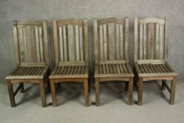 A set of four contemporary Barlow and Tyrie oak garden dining chairs, with slatted seats.