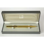 A mid 20th century boxed gold plated Dunhill rollerball pen. H.6 W.17.5 D.4cm. (box)