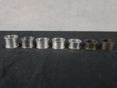 Seven assorted hallmarked silver napkin rings to include Coopers Brothers, Sheffield 1974; Joseph