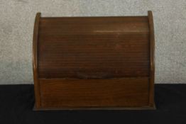 An early 20th century oak dome topped roll top letter rack, opening to reveal fitted interior. H.