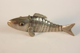 A 19th century Danish white metal vinaigrette in the form of an articulated fish, red paste eyes and