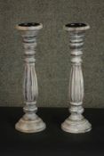A pair of painted and distressed wood pricket candlesticks, turned and reeded. H.44 Dia.13cm.