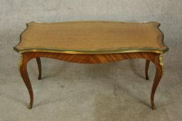 An early 20th century French Kingswood shaped coffee table Coffee table raised on shaped cabriole