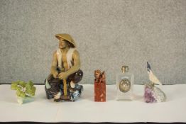 A 20th century Chinese porcelain figure of a seated man, together with a Chinese soapstone seal