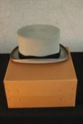 A boxed gentlemen's 20th century Moss Bros grey top hat. Size 7