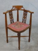 An Edwardian inlaid mahogany pierced splat back corner chair with embroidered seat, raised on X
