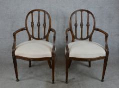 A pair of 20th century mahogany framed balloon back open arm chairs with turned spindles raised on