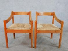 A pair of mid 20th century Vico Magistretti for Cassini beech framed open armchairs, with drop in