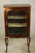 A late 19th century mahogany single glass door display cabinet opening to reveal three shelves,