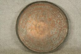 A late 19th/early 20th century engraved circular copper tray. Dia.65cm.