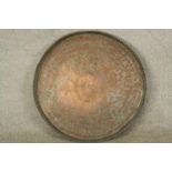 A late 19th/early 20th century engraved circular copper tray. Dia.65cm.