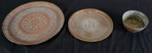 Two 20th century Middle Eastern engraved brass circular gallery trays, together with an engraved
