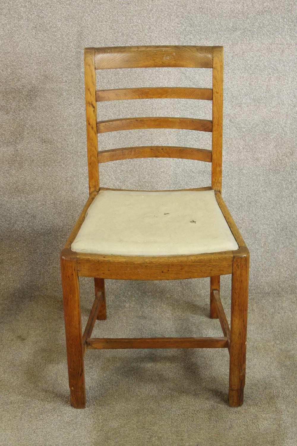 A pair of early 20th century oak framed ladder back chairs, raised on carved supports with drop in - Image 3 of 8