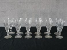 A set of twelve 19th century cut glass tapering wine glass raised on knop stem terminating in