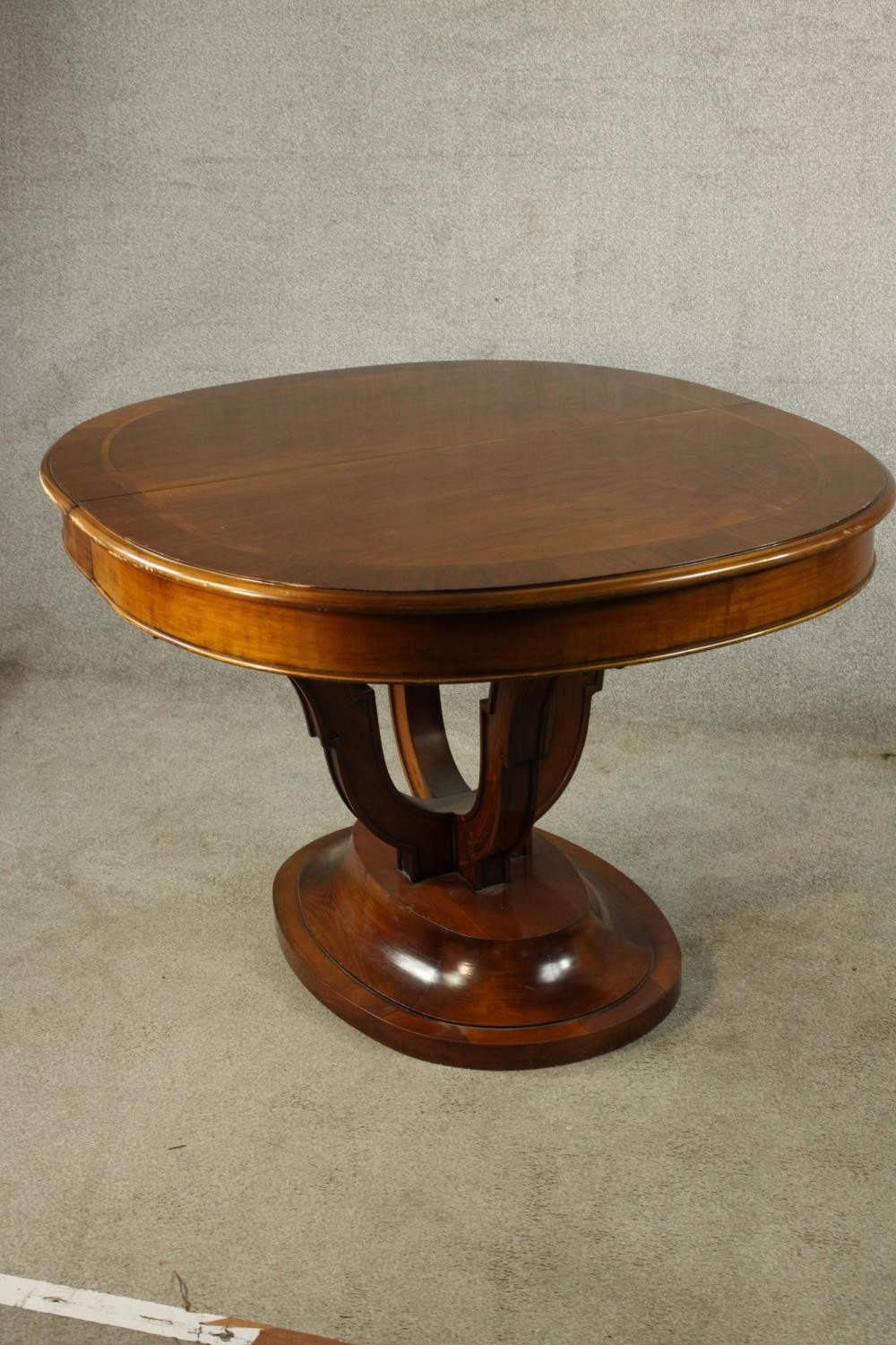 A 20th century mahogany pull oval extendable table, on four carved trumpeting supports terminating - Image 4 of 10