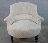 A 19th century mahogany framed nursing chair, upholstered in cream Dralon fabric raised on turned