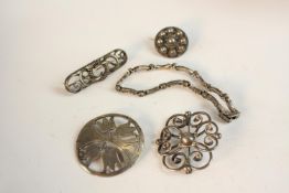 A collection of white metal and Danish silver brooches along with a peridot and marcasite set silver
