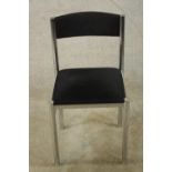 A contemporary chrome plated framed single chair with blue upholstered drop in seat, raised on