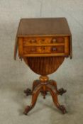 A 19th century mahogany dropleaf and two drawer sewing table raised on four carved outswept supports