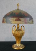 A 20th century table lamp with reverse glass painted light shade, standing on a twin swan/crane head