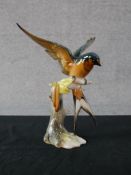 A 20th century German HUTSCHENREUTHER, G. Granget painted porcelain model of a swallow sitting on