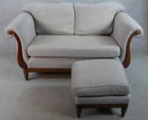 A 20th century mahogany framed two seater scroll arm settee upholstered in grey fabric raised on